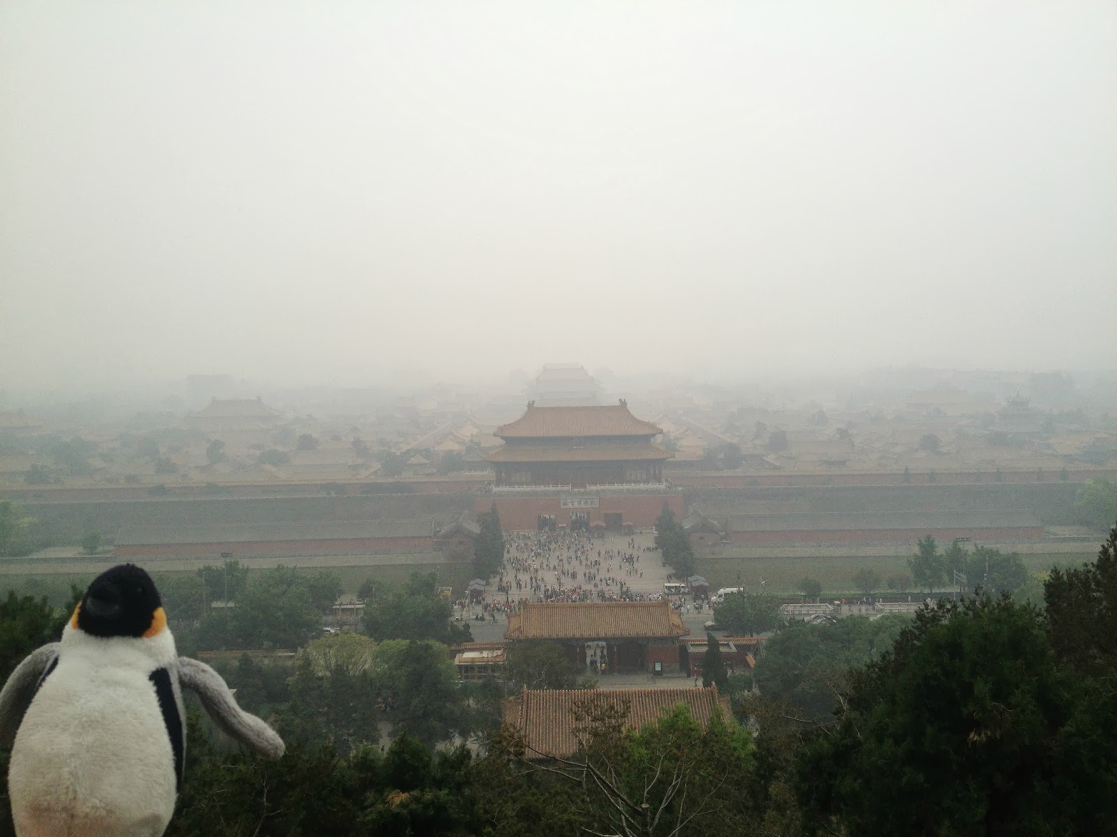 From pavilion atop hill in Jingshan Park, with the Forbidden City in the background.  We are looking south, i.e. the large structure in the center is the northernmost gate of the FC.  We had entered from the south or Meridian gate, about 1 mile beyond and therefore barely visible in the smog.